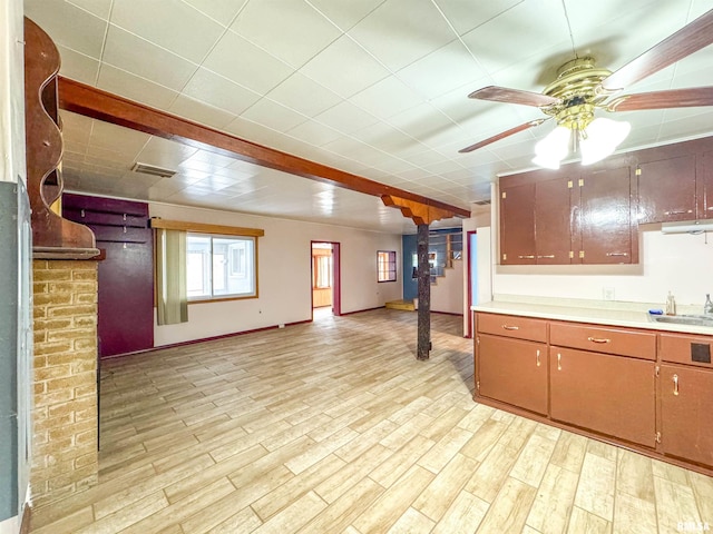 kitchen with light hardwood / wood-style floors, ceiling fan, and sink