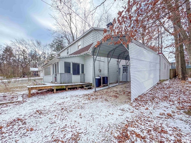 exterior space with central air condition unit, a deck, a carport, and a sunroom