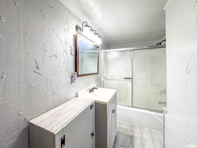 bathroom featuring vanity and enclosed tub / shower combo