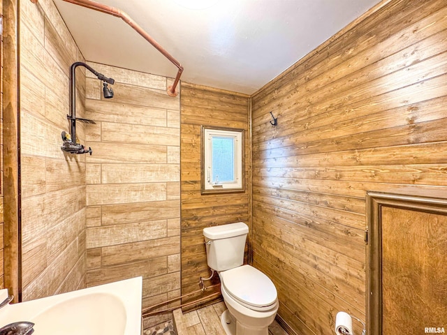 bathroom with hardwood / wood-style floors, wood walls, and toilet