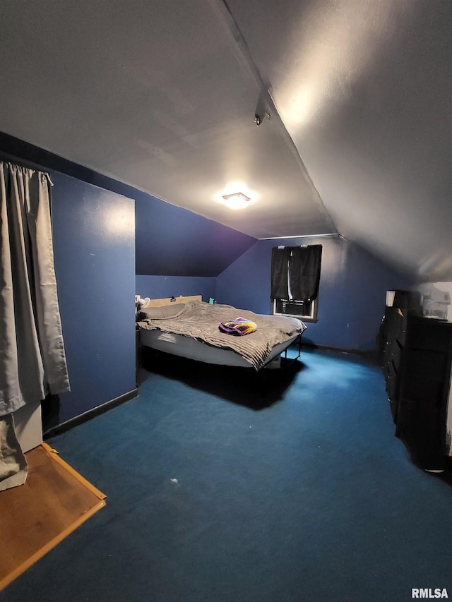 unfurnished bedroom with dark carpet and vaulted ceiling