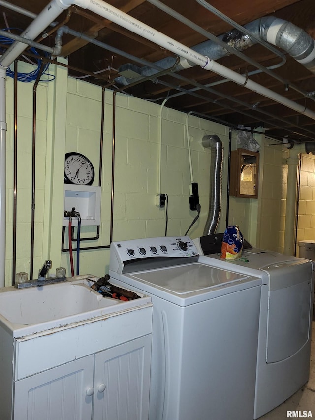 laundry area with independent washer and dryer and sink