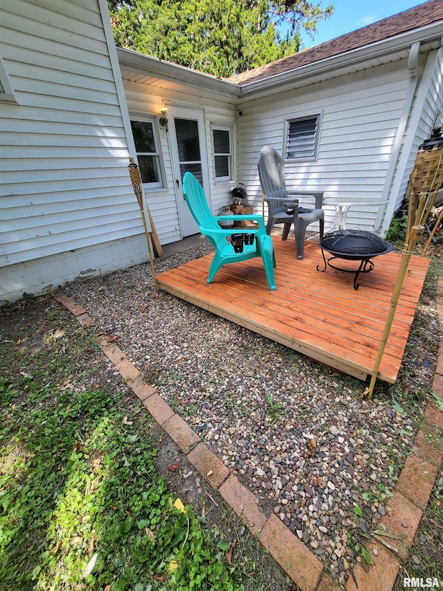 wooden terrace featuring a fire pit