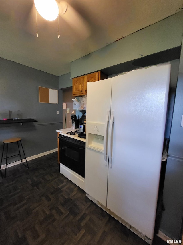 kitchen with dark parquet floors and white appliances