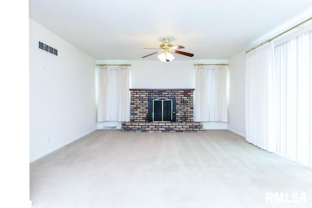 unfurnished living room featuring carpet flooring, ceiling fan, and a fireplace