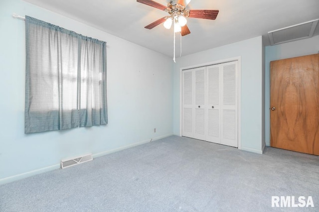 unfurnished bedroom with ceiling fan, light colored carpet, and a closet