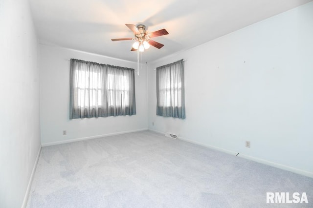 carpeted empty room featuring ceiling fan