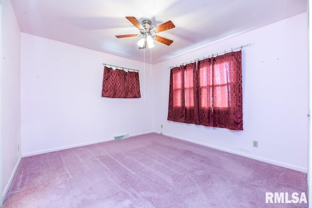 empty room featuring ceiling fan and light colored carpet