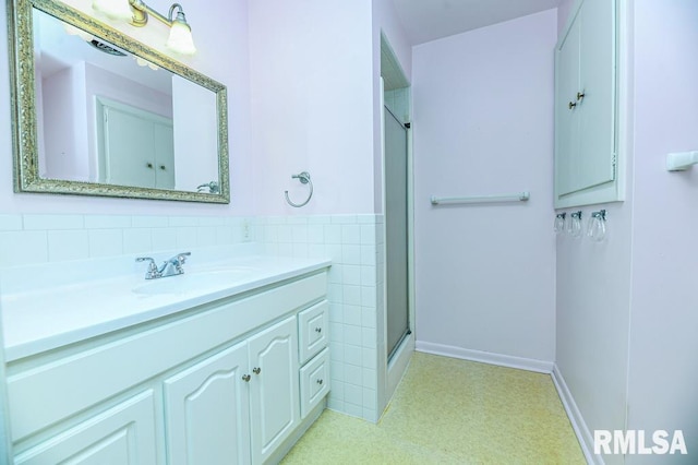 bathroom featuring vanity and a shower with shower door