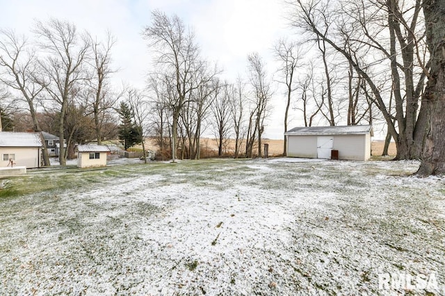 yard layered in snow featuring an outdoor structure