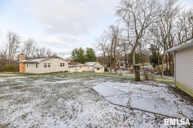 view of yard layered in snow