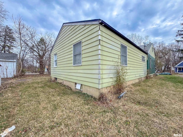 view of property exterior featuring a lawn