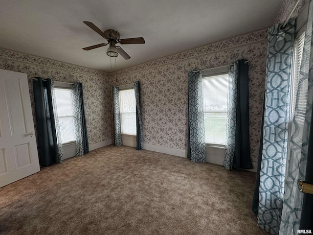 unfurnished room with carpet and ceiling fan