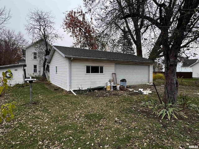 back of house featuring an outbuilding and a garage