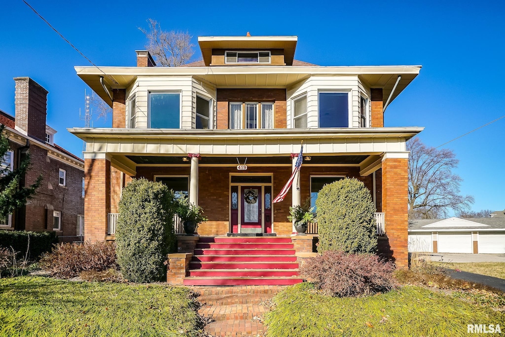 view of front of property featuring covered porch and brick siding