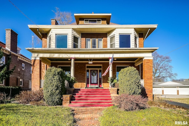 view of front of property featuring covered porch and brick siding