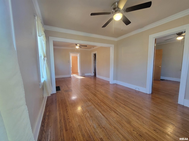 empty room with wood-type flooring, ceiling fan, and crown molding