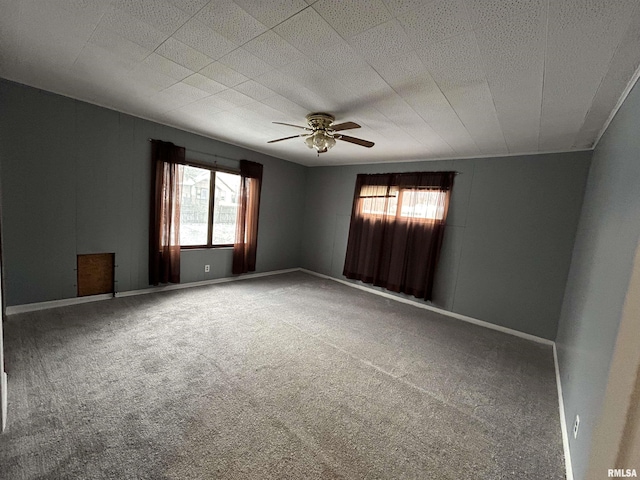 spare room with ceiling fan, carpet floors, and a wealth of natural light