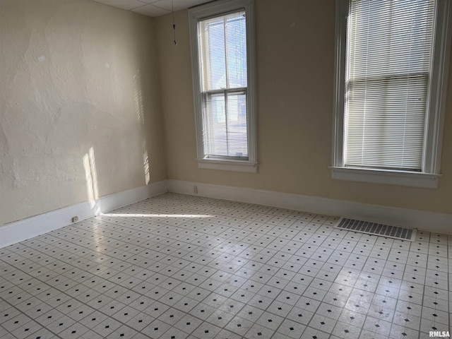 unfurnished room featuring plenty of natural light