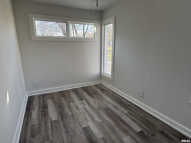 unfurnished room with dark wood-type flooring