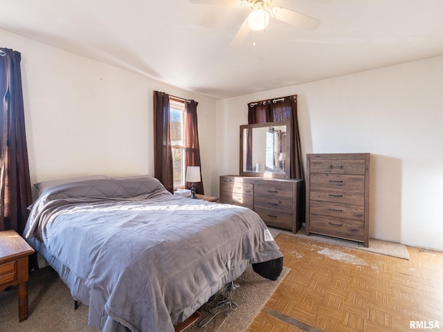 bedroom with light parquet floors and ceiling fan