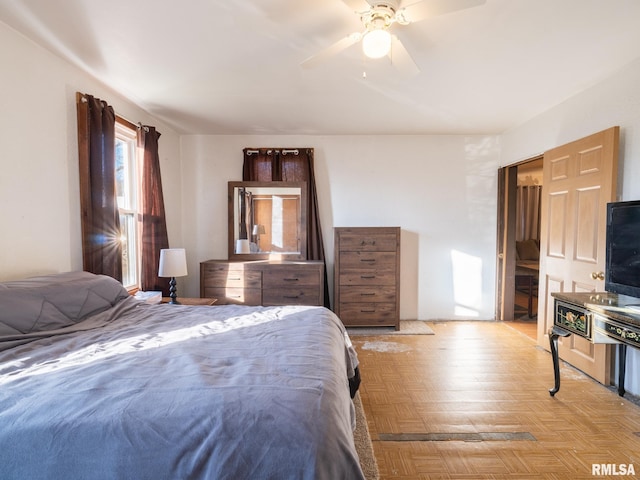 bedroom with ceiling fan and light parquet flooring