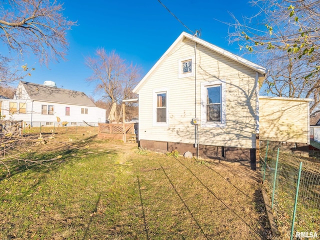 rear view of house with a yard