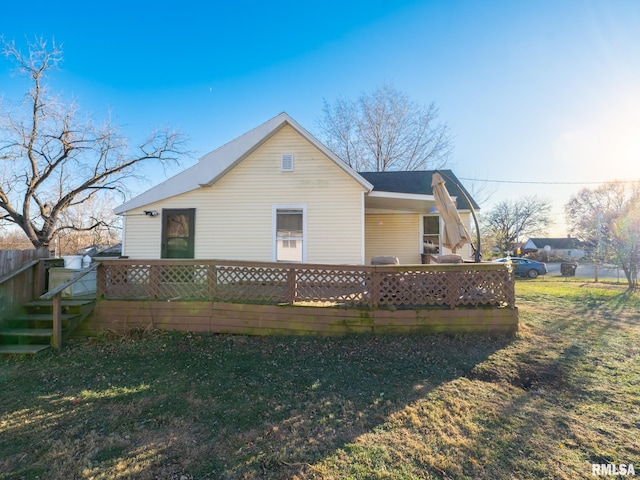 rear view of property featuring a yard