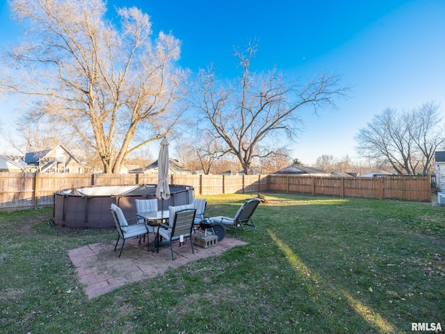 view of yard with a fenced in pool and a patio area