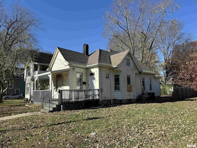 view of home's exterior with a porch and a yard