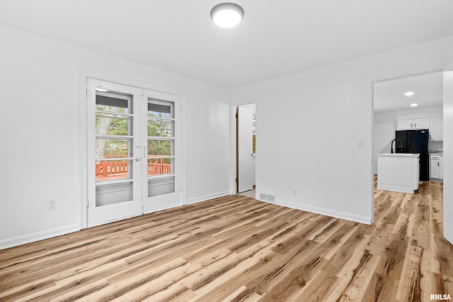 empty room with light hardwood / wood-style floors