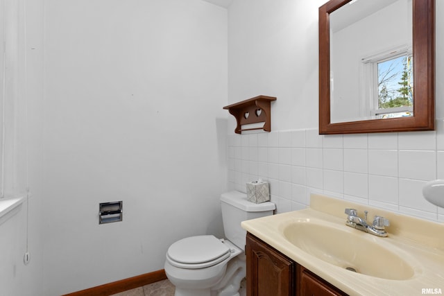 bathroom with vanity, tile walls, and toilet