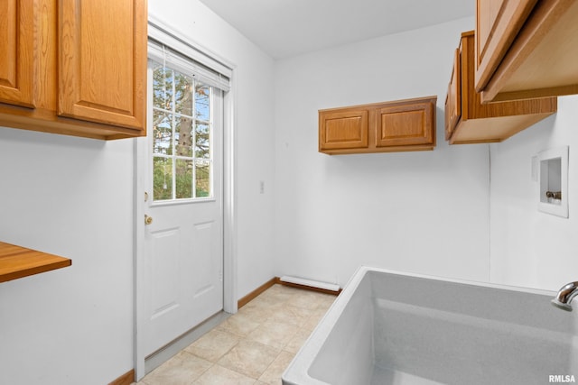 interior space with sink, cabinets, and washer hookup