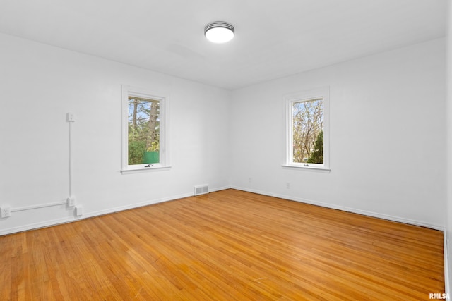 unfurnished room with light hardwood / wood-style floors