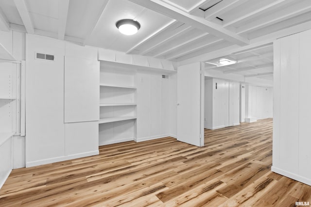 interior space featuring beam ceiling and light wood-type flooring