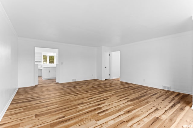 unfurnished room with light hardwood / wood-style floors and ornamental molding