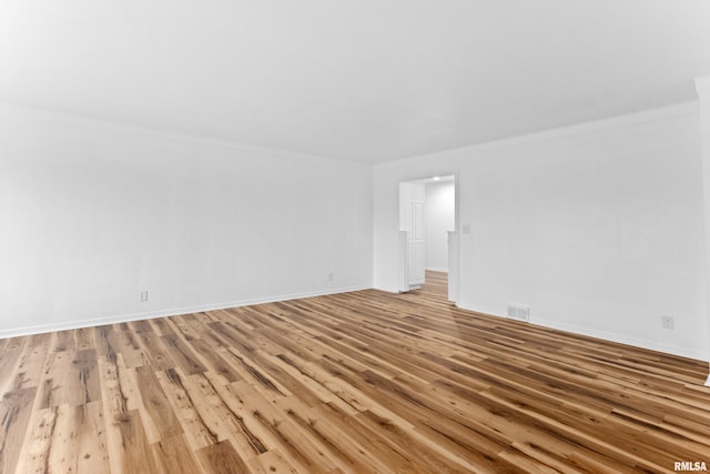 unfurnished room with ornamental molding and light hardwood / wood-style flooring