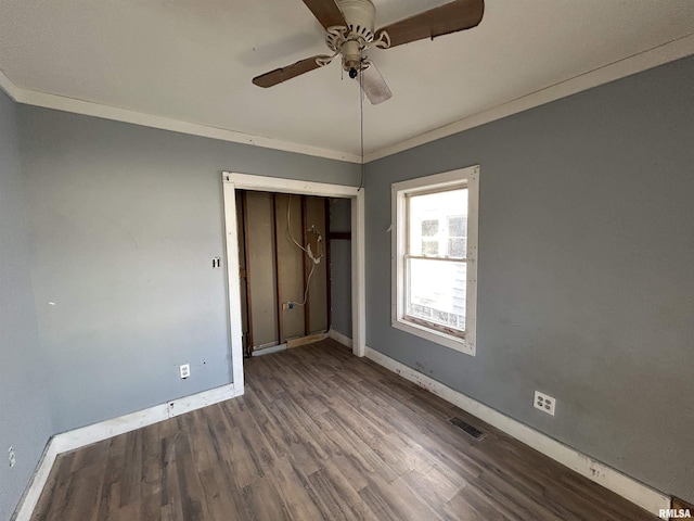 unfurnished bedroom with crown molding, ceiling fan, a closet, and wood-type flooring