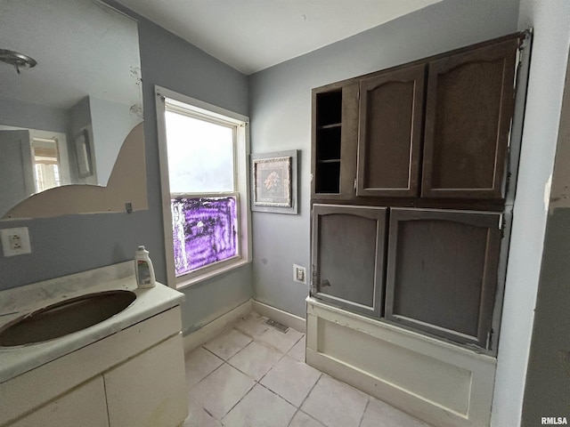 bathroom featuring tile patterned flooring and vanity