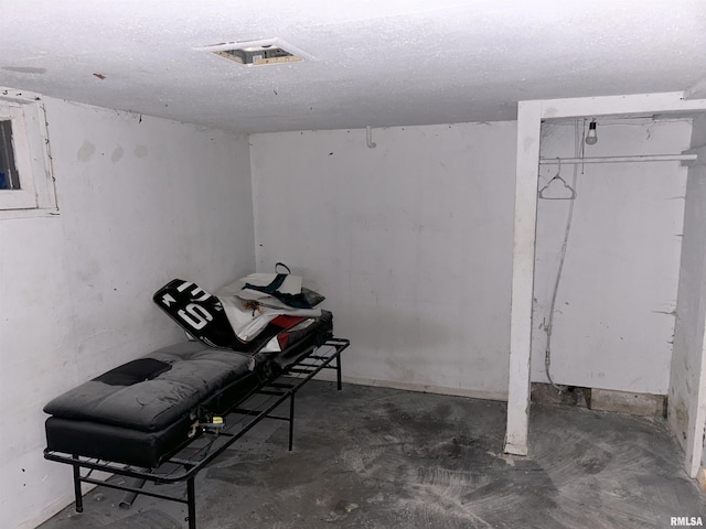 basement featuring a textured ceiling