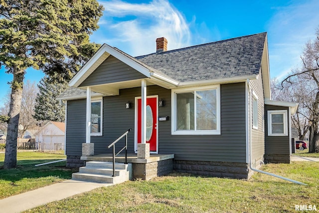 bungalow-style house with a front lawn