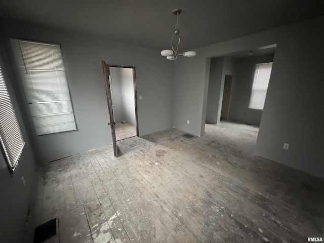 unfurnished dining area featuring a chandelier