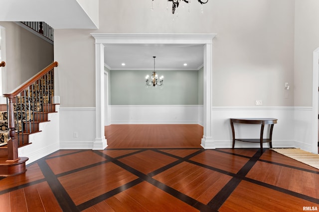 dining area featuring baseboards, ornamental molding, wood finished floors, a chandelier, and recessed lighting