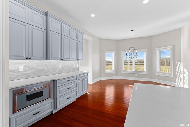 kitchen featuring dark wood-style floors, a wealth of natural light, backsplash, and recessed lighting