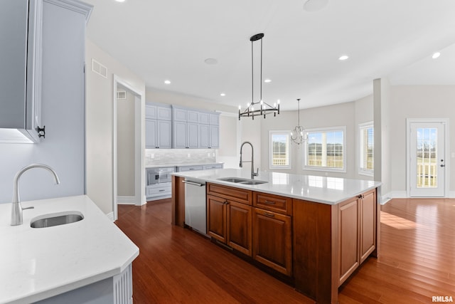 kitchen with dishwasher, visible vents, light countertops, and a sink