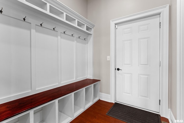 mudroom featuring baseboards and dark wood finished floors