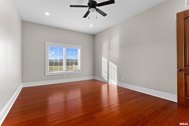 empty room featuring ceiling fan, recessed lighting, wood finished floors, and baseboards