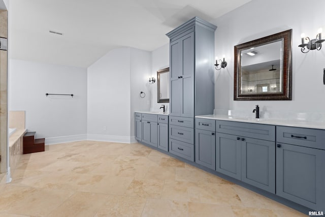 full bathroom featuring lofted ceiling, visible vents, vanity, and baseboards