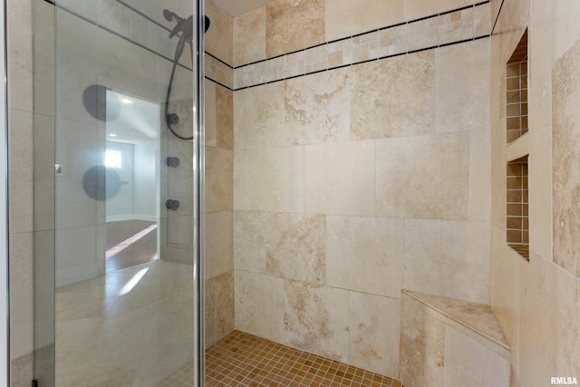 bathroom with a tile shower