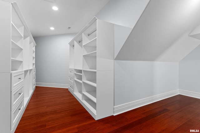 walk in closet featuring dark wood-style floors and lofted ceiling